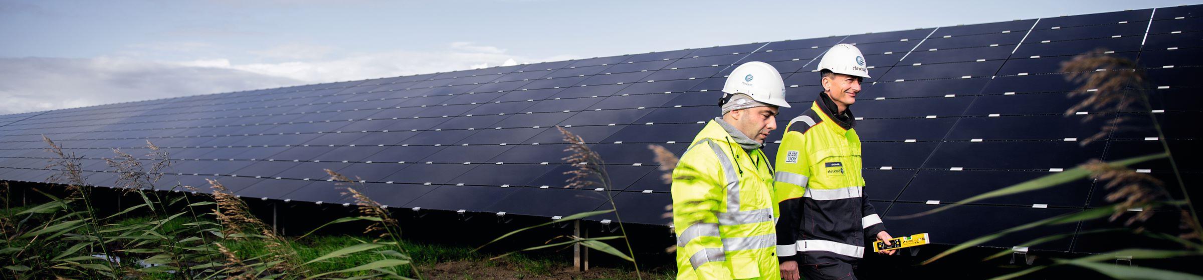 Men walking in solar park